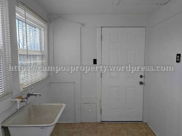 Laundry room with storage and full-sized antique sink.