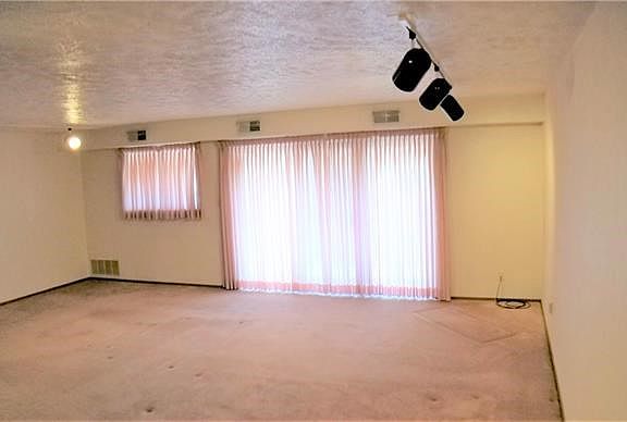 View from entry into large sliding glass doors onto deck and living and dining areas.