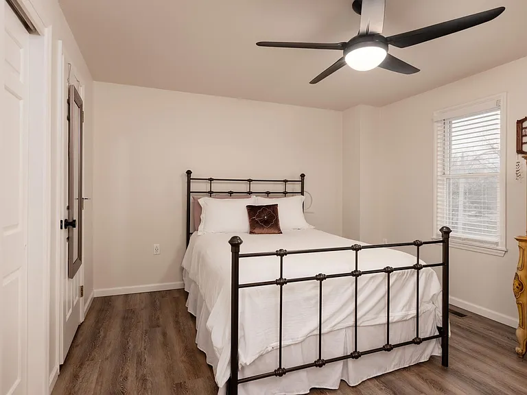 MBR. Closet on left next to full bathroom. Windows face front. Out of photo is a second, walk-in closet