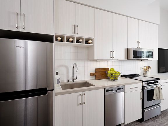 Stainless steel appliances, quartz countertops and wine storage