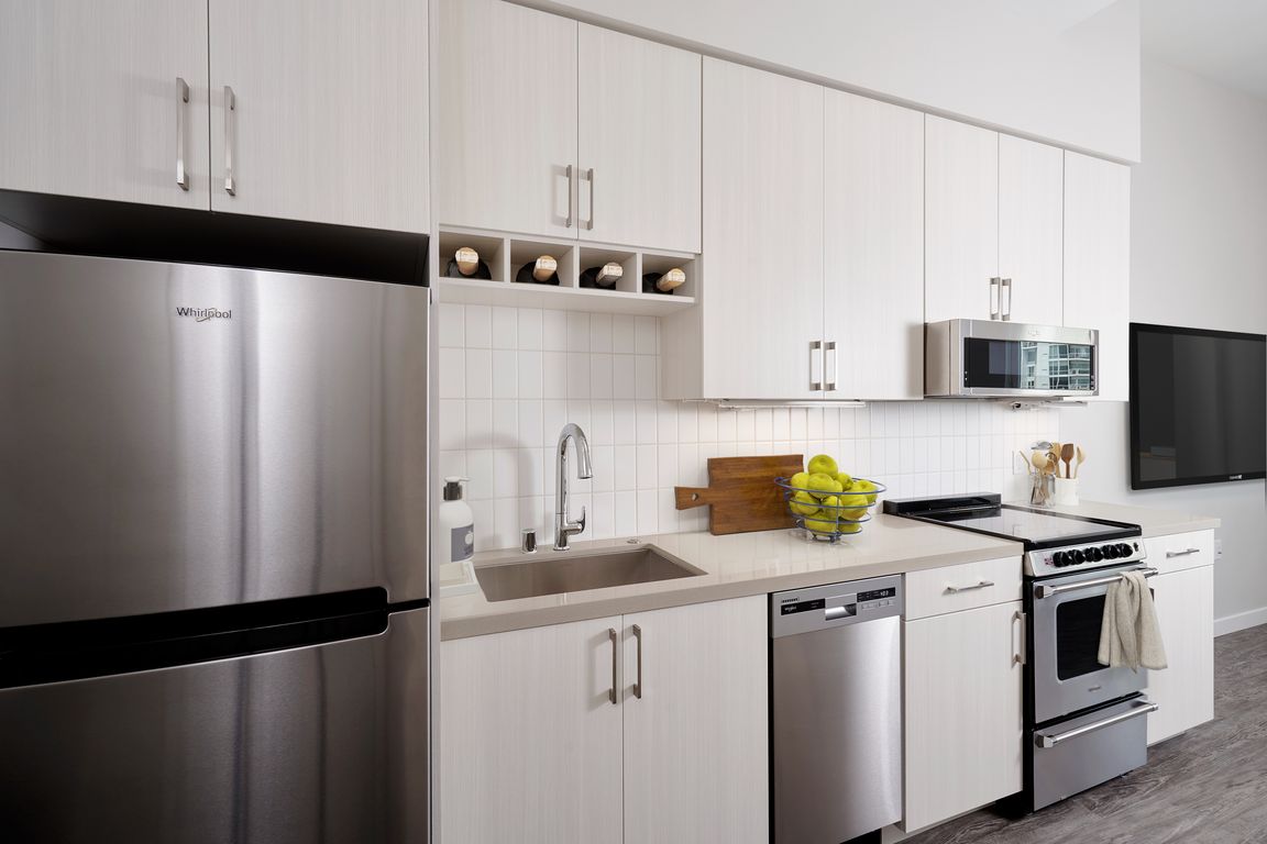 Stainless steel appliances, quartz countertops and wine storage