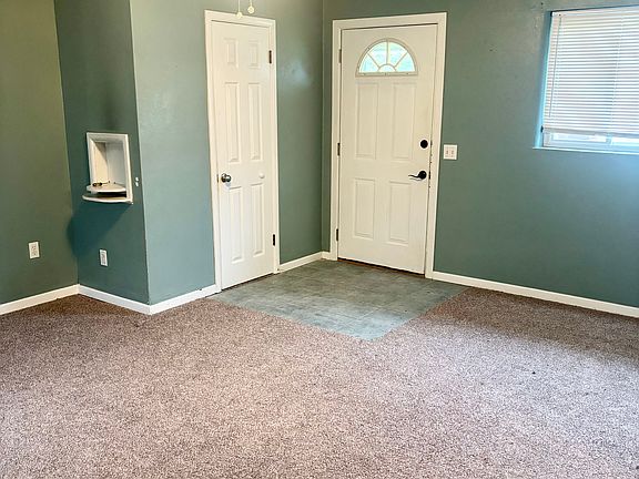 Living room with coat closet.
