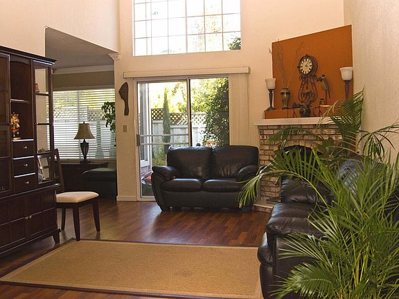 Living Room with Vaulted Ceilings & Laminate Wood Floors
