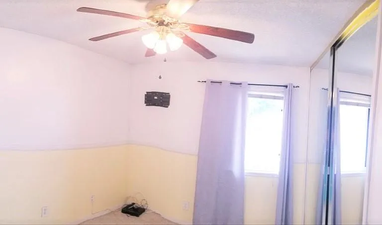 Empty Bedroom View Includes Ceiling Fan, TV Mount & Cable Box