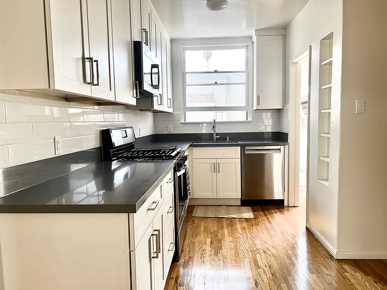 Completely new kitchen with endless natural light and original wood floors