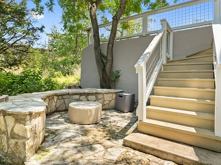 stairs leading to lower fire pit area and access to basement / game room + lower level decks and lake access