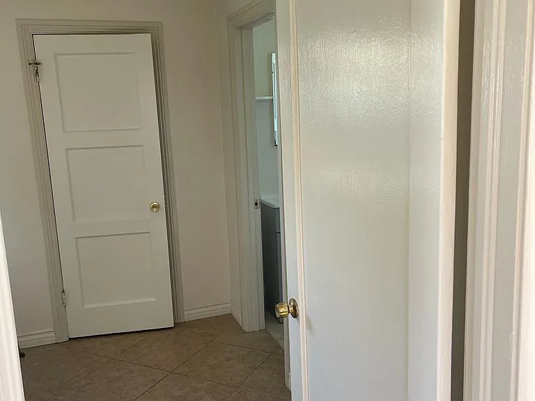 Bedroom with bathroom door on right