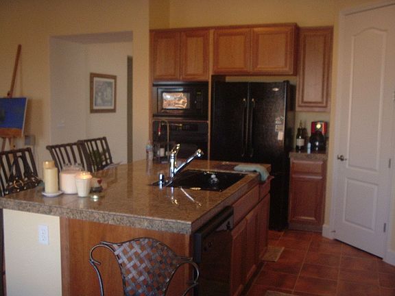 Kitchen with granite counters and cherry wood cabinets