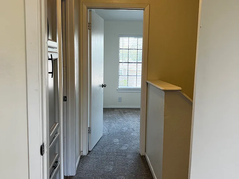 Both bedrooms are upstairs with ceiling fans and large windows