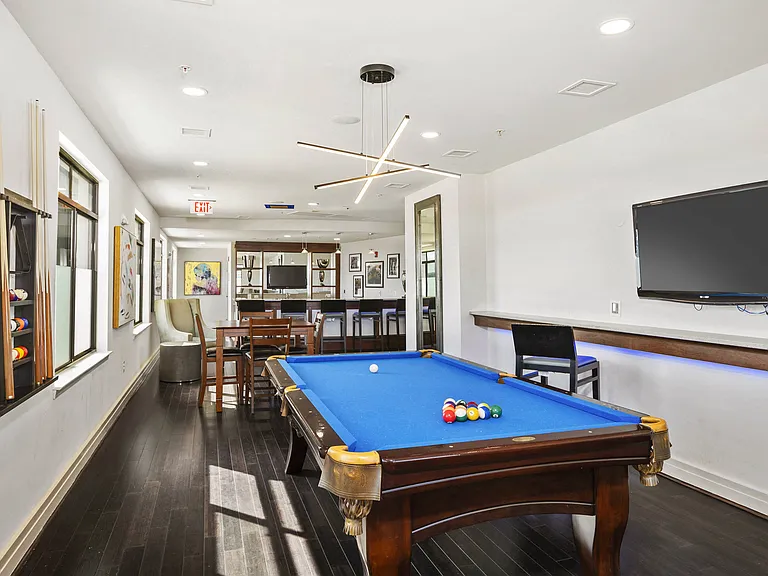 Exclusive resident lounge with kitchen, bar top, and billiards