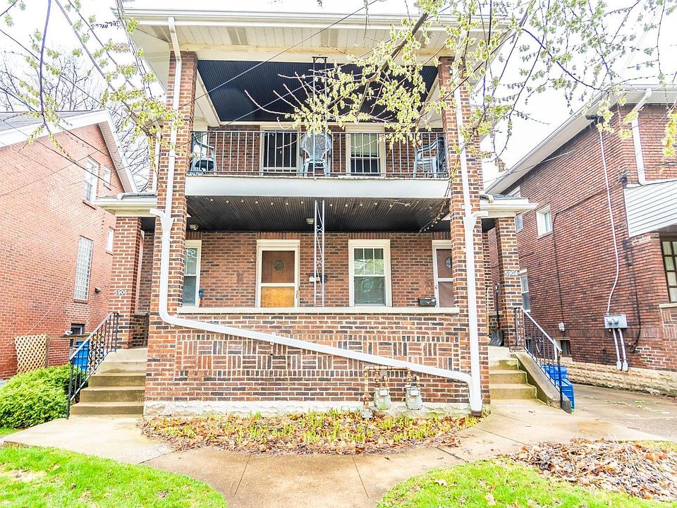 5906 Phillips Ave. is the first floor of this duplex. The driveway on the right side leads down to off-street parking and garages on the back of the duplex.