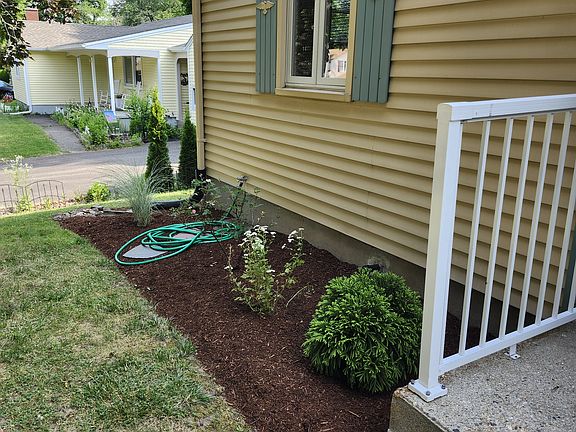 Flower beds front side of house.