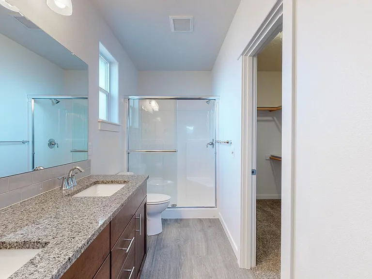 Master bath, with 2 sinks, step-in shower & large walk-in closet