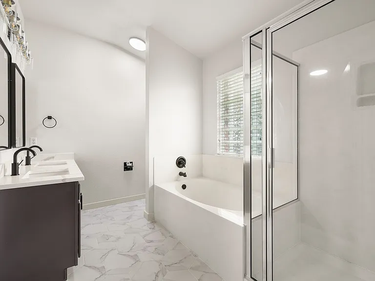 Fully remodeled master bathroom, with a shower and garden tub