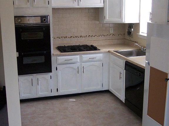 New refrigerator, new linoleum floor, and painted cabinets.