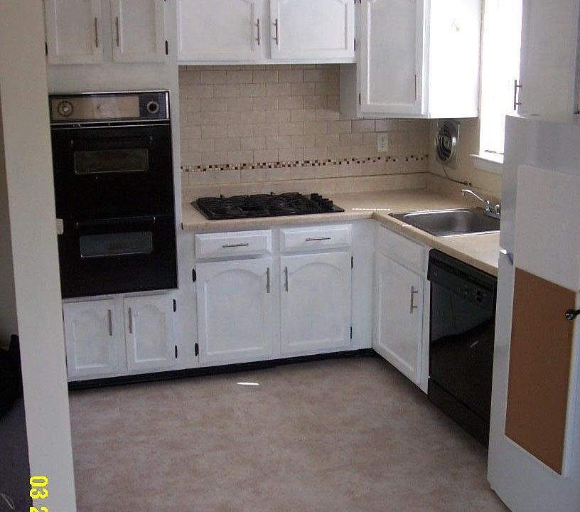 New refrigerator, new linoleum floor, and painted cabinets.