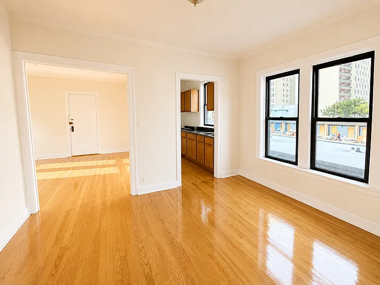 Dining room with Eastern exposure and living room, with main entry door shown in livining room