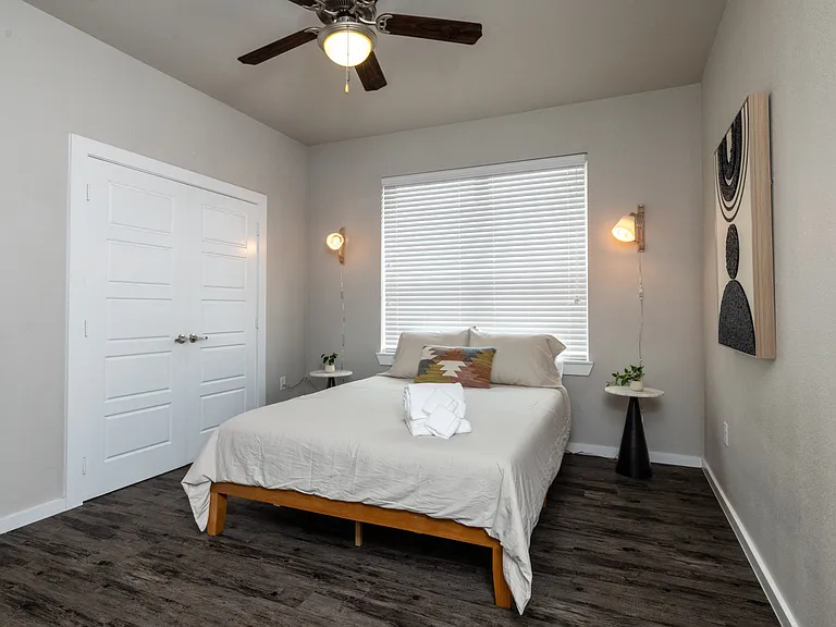 Inviting fourth bedroom with a queen bed and soft hanging lights on each side_simple, stylish, and made for a peaceful night's sleep. This bedroom is located upstairs.