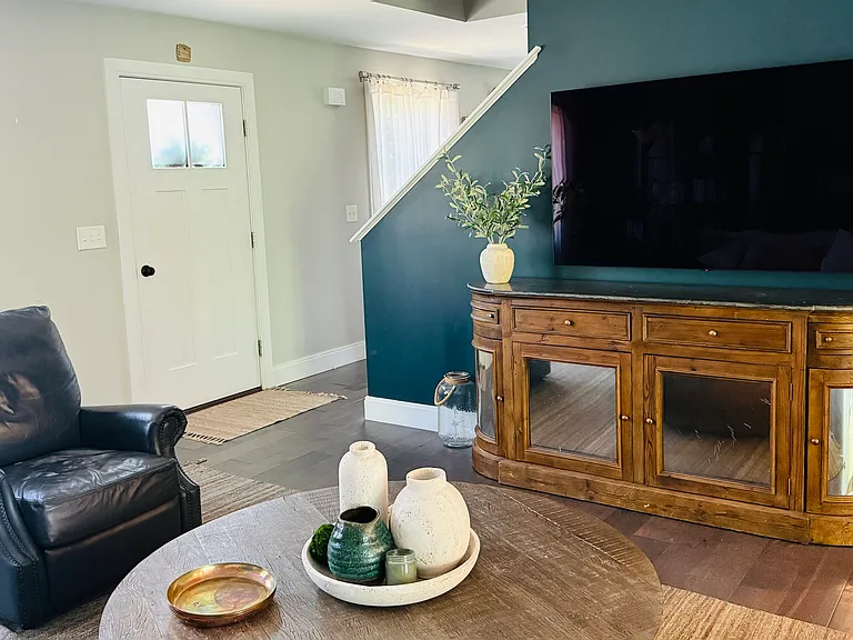 Living room, open. plan. Kitchen to the right. Dining room on the other side of the stairs.