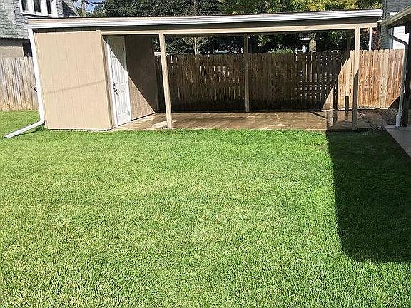 Covered carport with storage area.