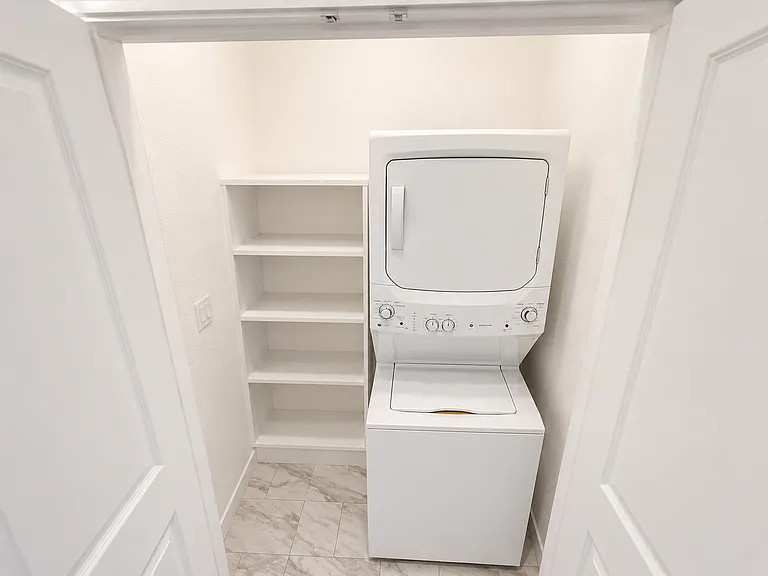 In-unit laundry featuring a washer and dryer.