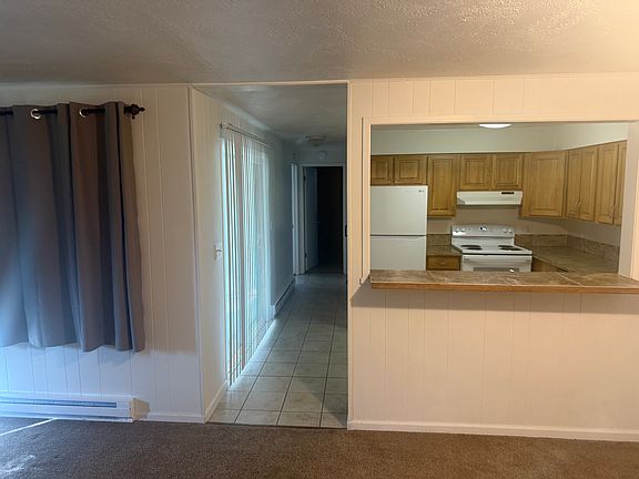 Looking from the dining area toward the kitchen, the sliding door opens onto a covered patio.