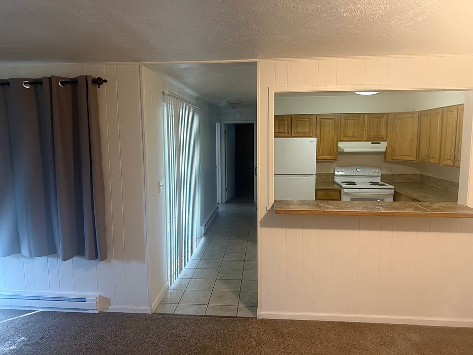 Looking from the dining area toward the kitchen, the sliding door opens onto a covered patio.