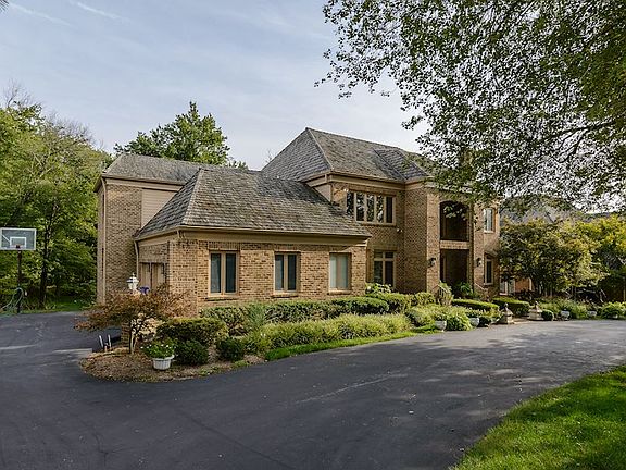 Circular drive, 3-car garage, double-hipped roof