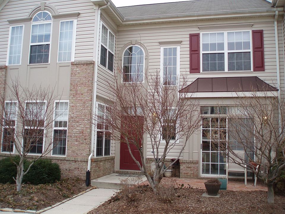 front of house w custom landscaping & brick patio