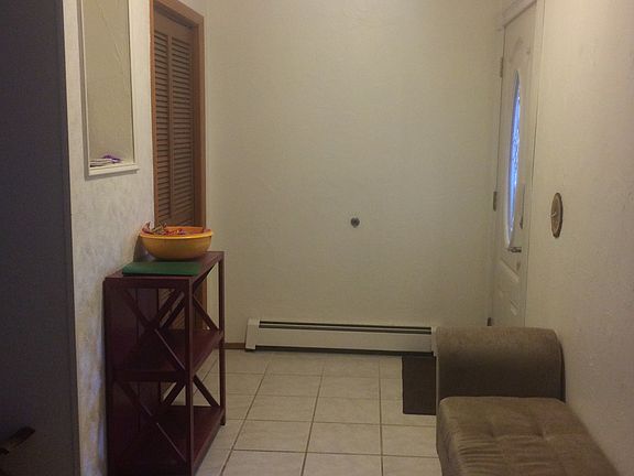 Tiled entry with closet
