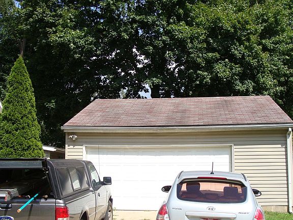 Large garage with work bench and plenty of storage