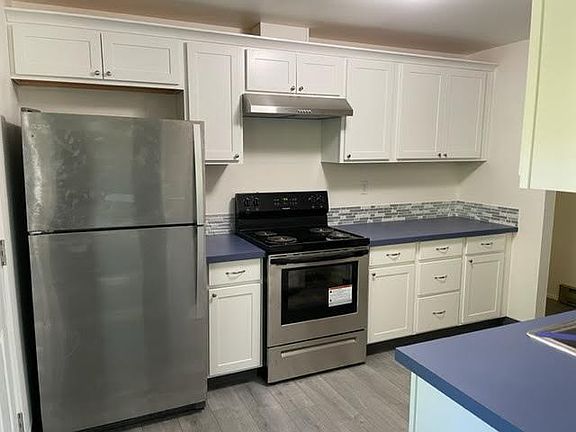 All new kitchen with stainless steel appliances and tile backsplashes