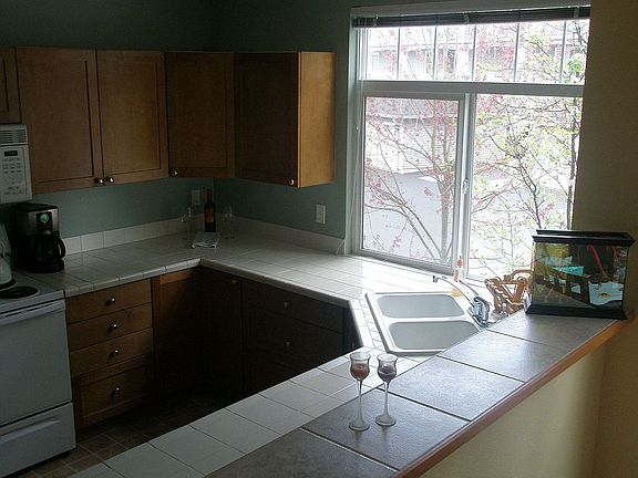 Tons of Oak cabinets and tiled counters