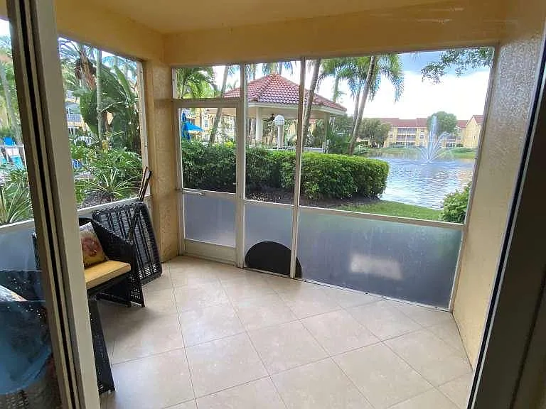 tiled lanai overlooking pond with lower privacy panels to help keep dirt out. Just steps away from community pool!