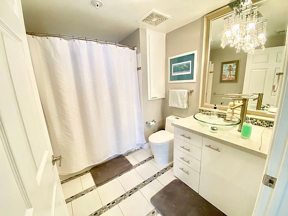 Spacious private bath with shower over full size tub.
