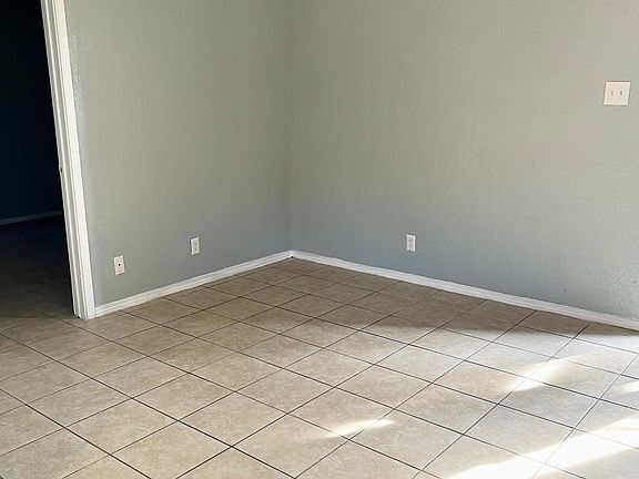 Living room area, standard with ceiling fan.