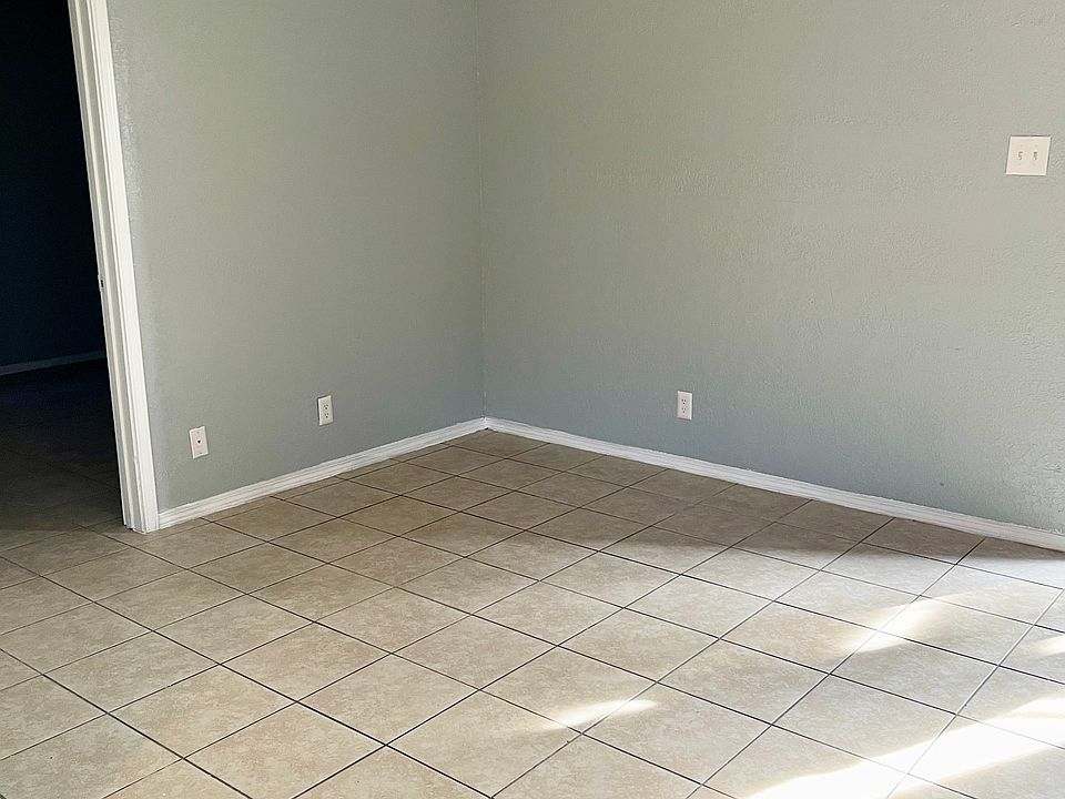 Living room area, standard with ceiling fan.