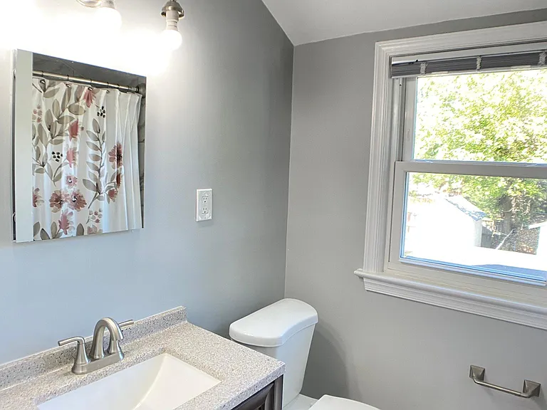 Updated full bathroom with bathtub on upper level.