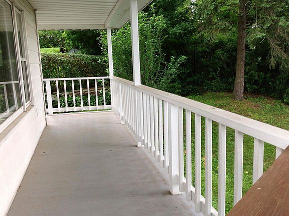 Deck wraps around back of house facing backyard.