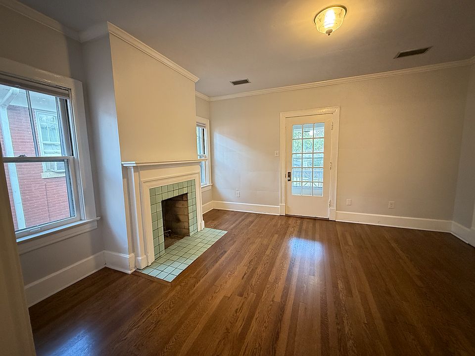 The aqua tile surrounding the fireplace is original and its the most beautiful color! There are 2 windows flanking the fireplace. Unfortunately the fireplace is NOT usable but great for ambiance Hardwood floors are freshly refinished.