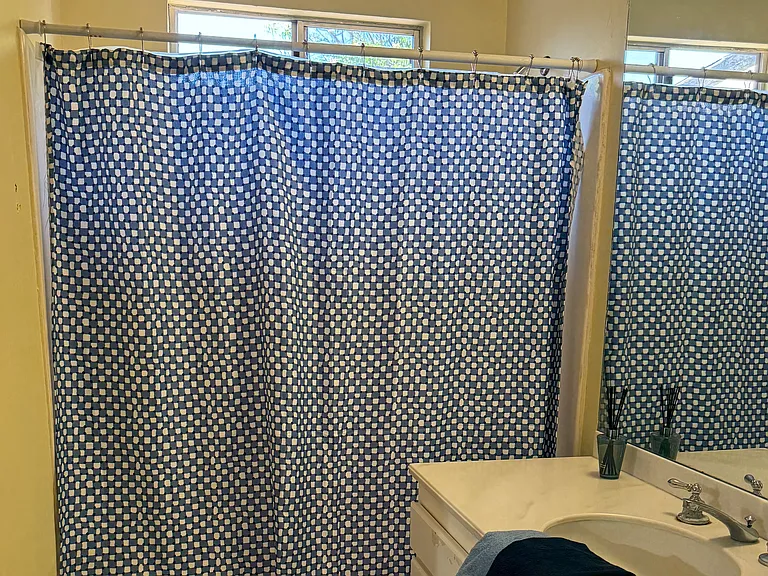 Bright and sunny full-size bathroom with shower/tub.