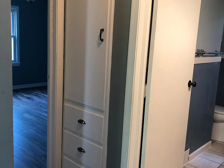 Hallway linen storage and master bath from hallway.