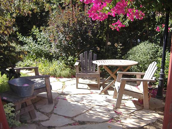 Access charming private back yard through the utility room next to kitchen or through bedroom back door.