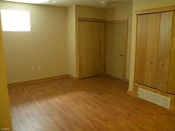 Living room with coat closet and solid wood doors