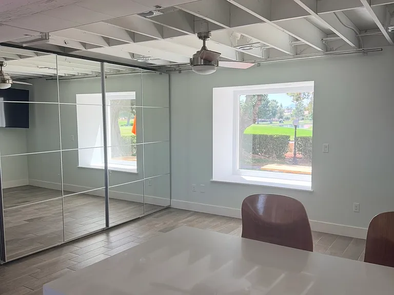 Kitchen view into living room with golfcourse picture window.