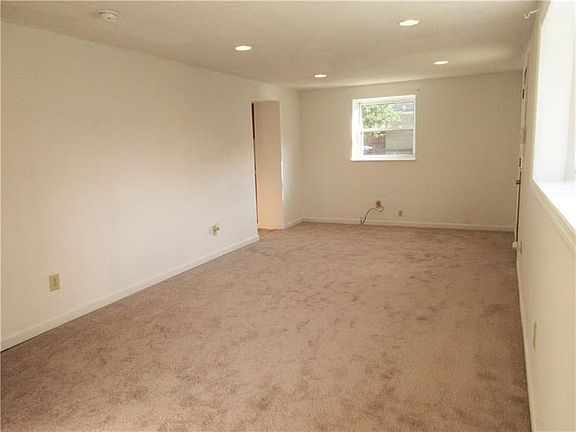 The living room also features brand new carpet and leads into the kitchen!