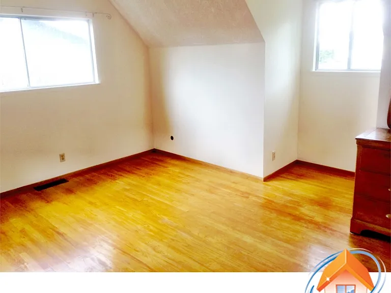 Master bedroom with two windows and walk-in closet