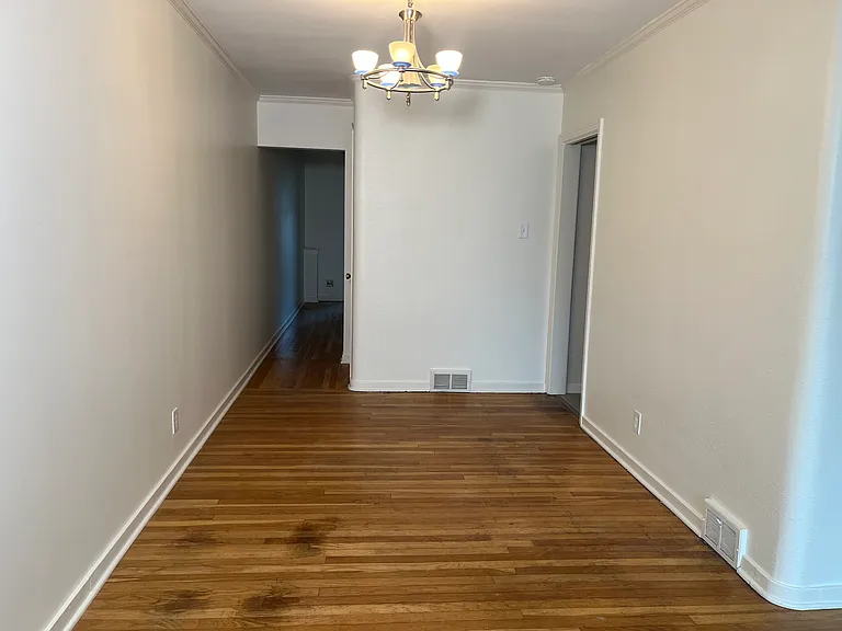 Dining area of main room (9' x 10'). Kitchen on right and hallway to bedrooms at rear.