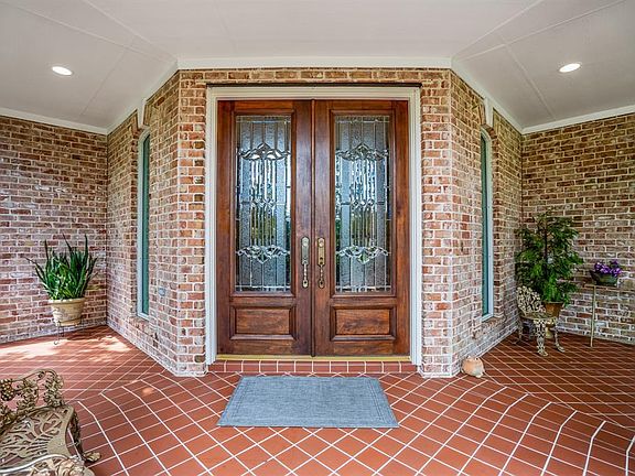 Beautiful terracotta tiled front porch leads through double mahogany and leaded glass doors.