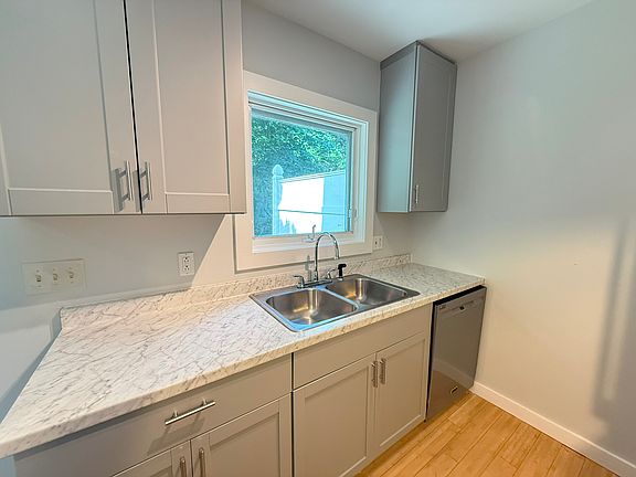 enjoy doing dishes while looking out at lush greenery from your kitchen window